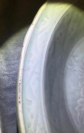 A Chinese Longquan celadon dish with underglaze design of peonies, Ming