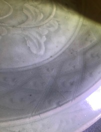 A Chinese Longquan celadon dish with underglaze design of peonies, Ming
