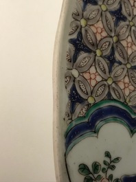 A pair of Chinese famille verte 'mythical beasts' chargers, Kangxi