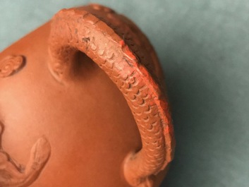 Een Chinese Yixing steengoed theepot met reli&euml;fdecor van draken, Kangxi