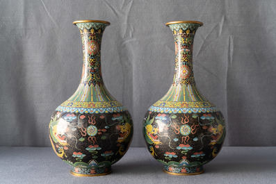 A pair of Chinese cloisonn&eacute; bottle vases, two silver saucers and a silver cup, 19/20th C.