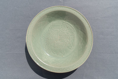 A Chinese Longquan celadon dish with underglaze design of peonies, Ming