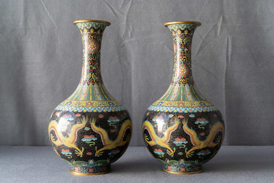 A pair of Chinese cloisonn&eacute; bottle vases, two silver saucers and a silver cup, 19/20th C.