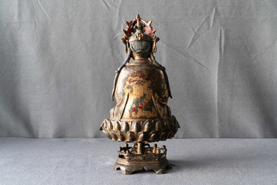 A Chinese gilt-lacquered bronze figure of Guanyin on a lotus throne, Ming