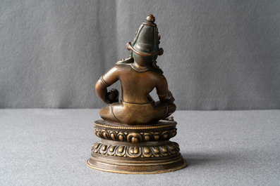 A Sino-Tibetan bronze figure of Jambhala, 17/18th C.