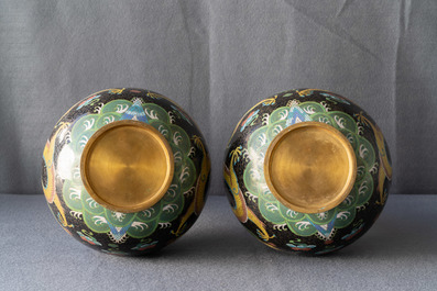 A pair of Chinese cloisonn&eacute; bottle vases, two silver saucers and a silver cup, 19/20th C.