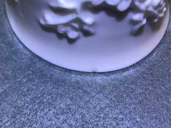 Three Chinese blanc de Chine vases and two cups with applied designs, Kangxi and later