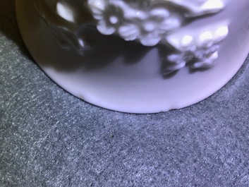 Three Chinese blanc de Chine vases and two cups with applied designs, Kangxi and later