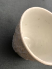 Three Chinese blanc de Chine vases and two cups with applied designs, Kangxi and later