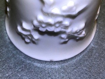 Three Chinese blanc de Chine vases and two cups with applied designs, Kangxi and later