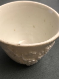 Three Chinese blanc de Chine vases and two cups with applied designs, Kangxi and later