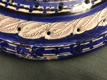 A large blue and manganese Frisian Delft fish strainer, Tichelaar, Makkum, 19th C.
