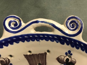 A large blue and manganese Frisian Delft fish strainer, Tichelaar, Makkum, 19th C.