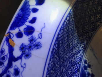 A pair of Chinese blue and white basins with figures in a garden, Yongzheng
