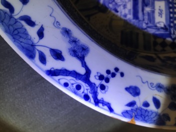A pair of Chinese blue and white basins with figures in a garden, Yongzheng