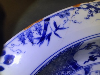 A pair of Chinese blue and white basins with figures in a garden, Yongzheng