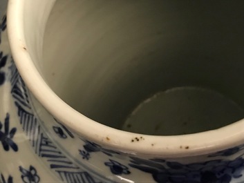 A pair of Chinese blue and white covered vases with floral design, Kangxi