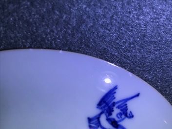 A pair of Chinese blue, white and underglaze red cups and saucers, Kangxi