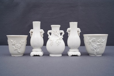 Three Chinese blanc de Chine vases and two cups with applied designs, Kangxi and later