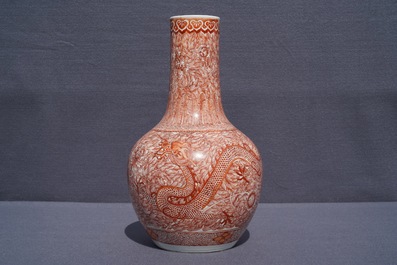 A Chinese iron red 'dragon and phoenix' bottle vase, 19th C.
