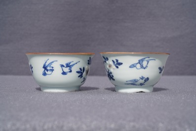 A pair of Chinese blue, white and underglaze red cups and saucers, Kangxi