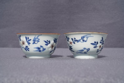 A pair of Chinese blue, white and underglaze red cups and saucers, Kangxi