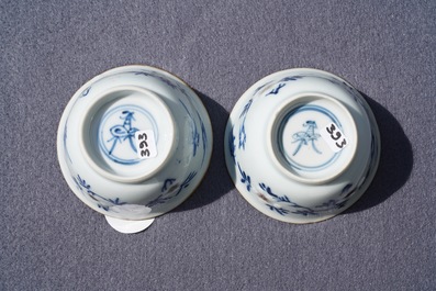 A pair of Chinese blue, white and underglaze red cups and saucers, Kangxi