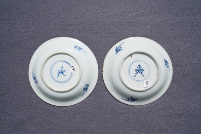 A pair of Chinese blue, white and underglaze red cups and saucers, Kangxi