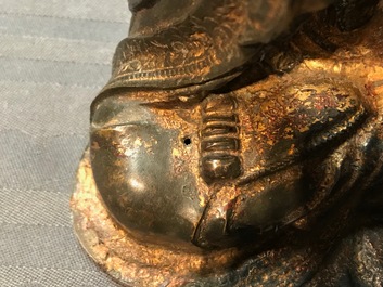 A Chinese gilt-lacquered bronze figure of Guanyin on a lotus throne, Ming