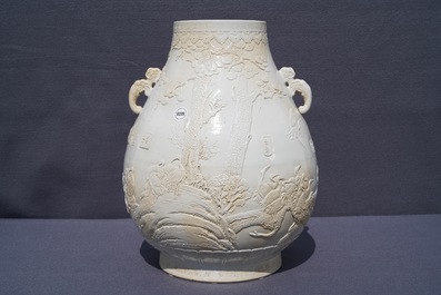 A Chinese monochrome cream-glazed relief-decorated hu vase, Qianlong mark, 20th C.