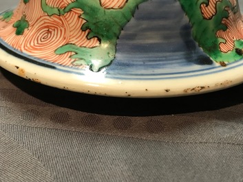 A pair of Chinese wucai 'galloping horses' vases and covers, Transitional period