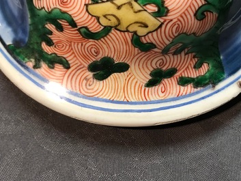 A pair of Chinese wucai 'galloping horses' vases and covers, Transitional period