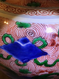 A pair of Chinese wucai 'galloping horses' vases and covers, Transitional period