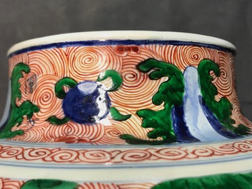 A pair of Chinese wucai 'galloping horses' vases and covers, Transitional period