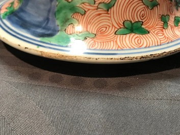 A pair of Chinese wucai 'galloping horses' vases and covers, Transitional period