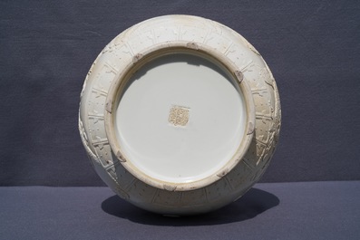 A Chinese monochrome cream-glazed relief-decorated hu vase, Qianlong mark, 20th C.