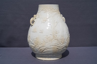 A Chinese monochrome cream-glazed relief-decorated hu vase, Qianlong mark, 20th C.