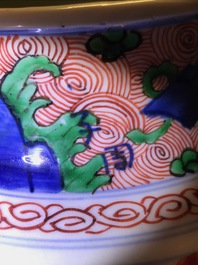A pair of Chinese wucai 'galloping horses' vases and covers, Transitional period