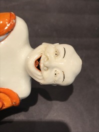 A Chinese iron red decorated figure of a Luohan, Qianlong