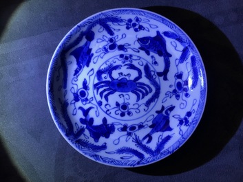 Six Chinese celadon and blue and white 'crabs and fish' cups and saucers, Kangxi