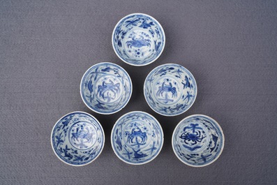 Six Chinese celadon and blue and white 'crabs and fish' cups and saucers, Kangxi