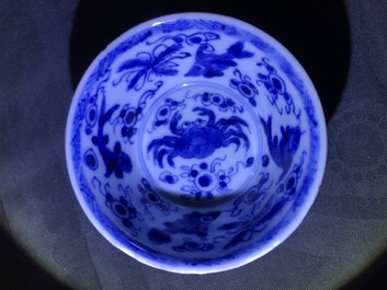 Six Chinese celadon and blue and white 'crabs and fish' cups and saucers, Kangxi