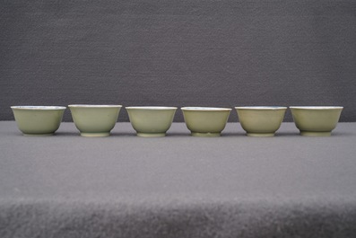 Six Chinese celadon and blue and white 'crabs and fish' cups and saucers, Kangxi