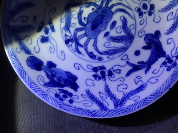 Six Chinese celadon and blue and white 'crabs and fish' cups and saucers, Kangxi