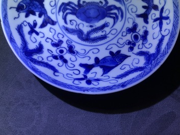 Six Chinese celadon and blue and white 'crabs and fish' cups and saucers, Kangxi