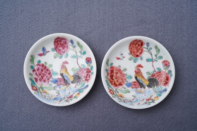 A pair of Chinese famille rose 'roosters' cups and saucers, Yongzheng/Qianlong