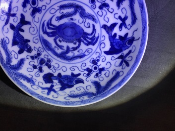 Six Chinese celadon and blue and white 'crabs and fish' cups and saucers, Kangxi