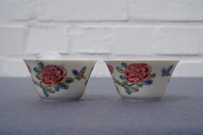A pair of Chinese famille rose 'roosters' cups and saucers, Yongzheng/Qianlong