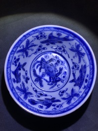 Six Chinese celadon and blue and white 'crabs and fish' cups and saucers, Kangxi