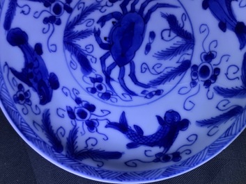 Six Chinese celadon and blue and white 'crabs and fish' cups and saucers, Kangxi